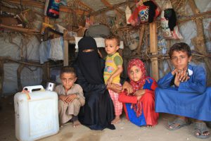 Daoshah-with-her-children-waiting-for-help-in-the-temporary-tent_They-lost-their-father-in-the-conflict