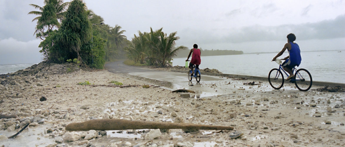 An image of a young boy riding his bicycle on the small Pacific island of Tuvalu