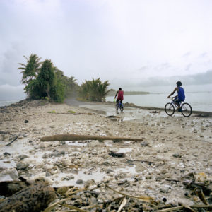 An image of a young boy riding his bicycle on the small Pacific island of Tuvalu